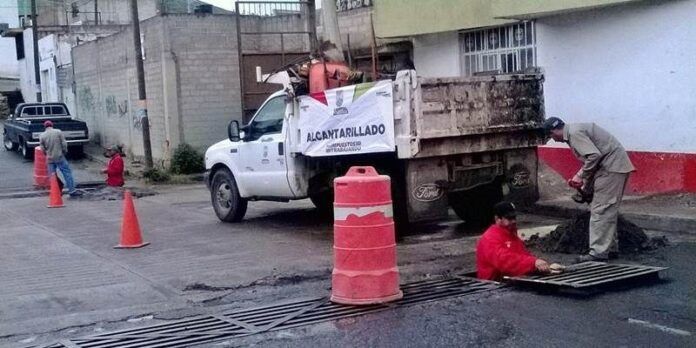 Trabajadores desazolvan alcantarillas Trabajadores desazolvan alcantarillas