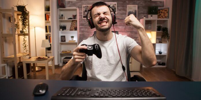 Pov of happy young man celebrating his victory on online shooter game