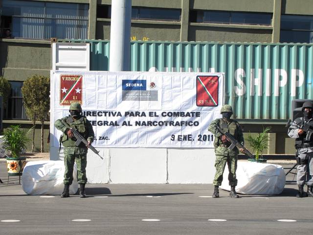 Militares resguardan un tractocamión y dos tráileres decomisados.